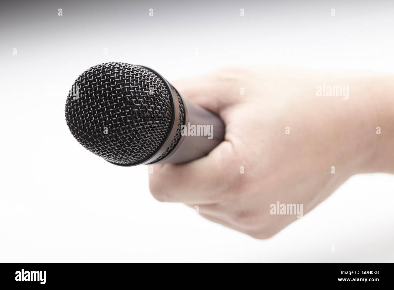 Microphone in a man's hand Stock Photo - Alamy