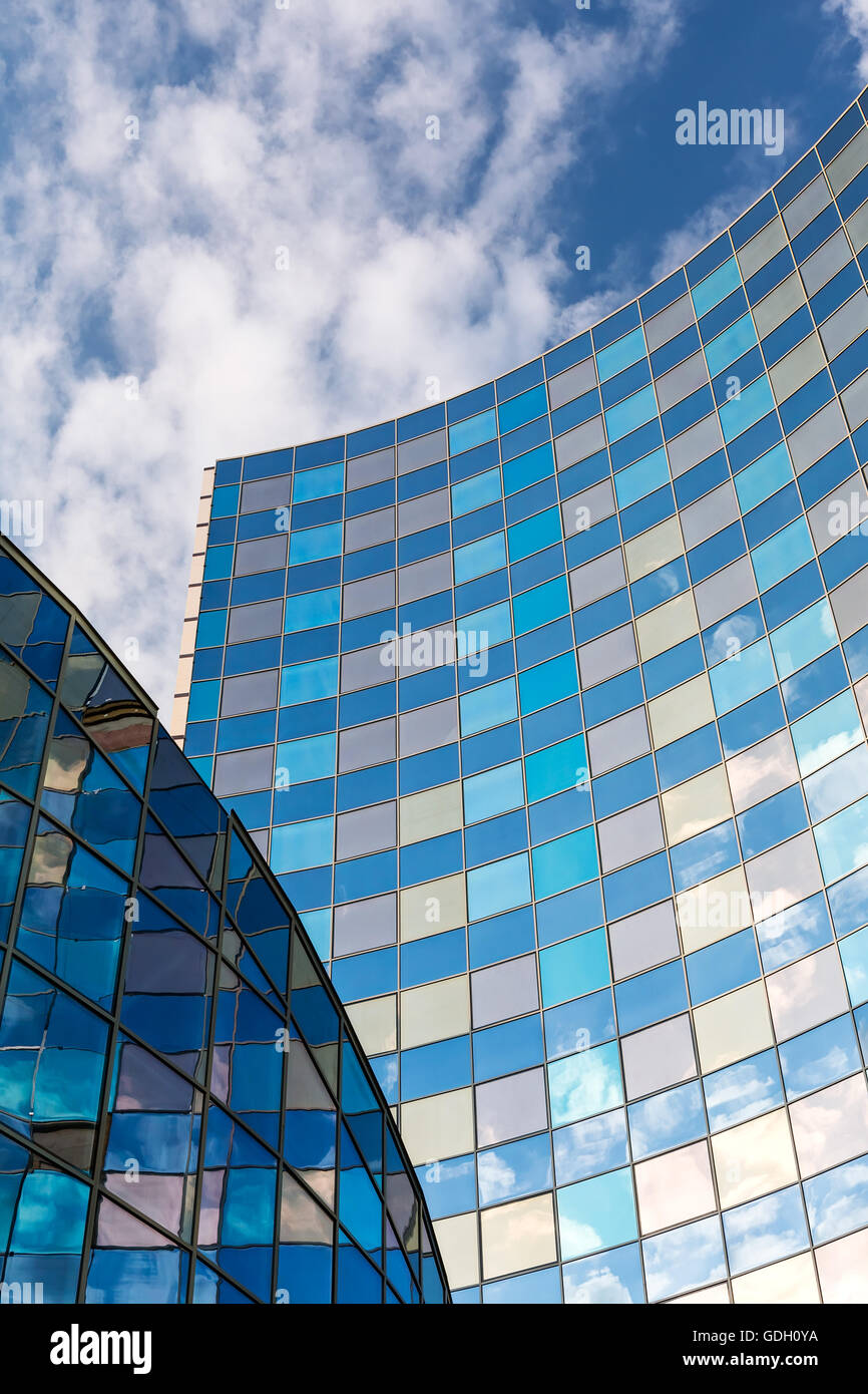 Reflection of a cloudy sky in glass wall of an office building Stock ...