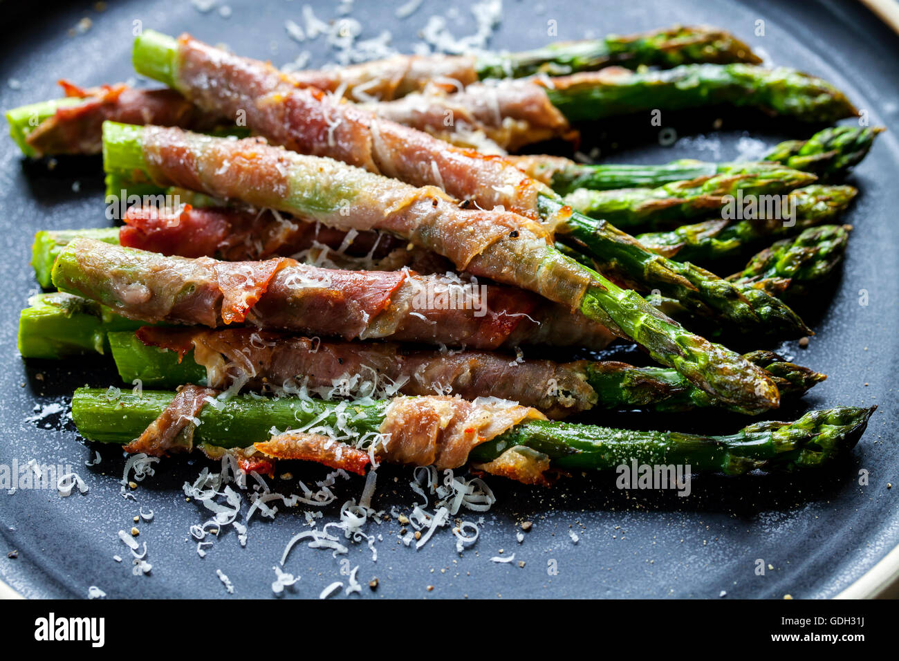 Grilled asparagus wrapped in Parma ham with parmesan, sage and thyme