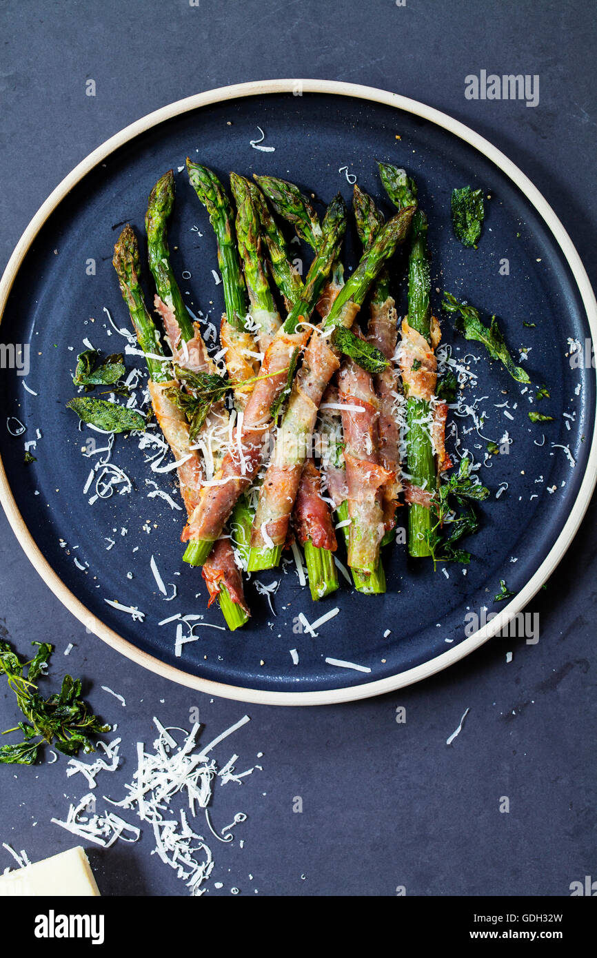 Grilled asparagus wrapped in Parma ham with parmesan, sage and thyme
