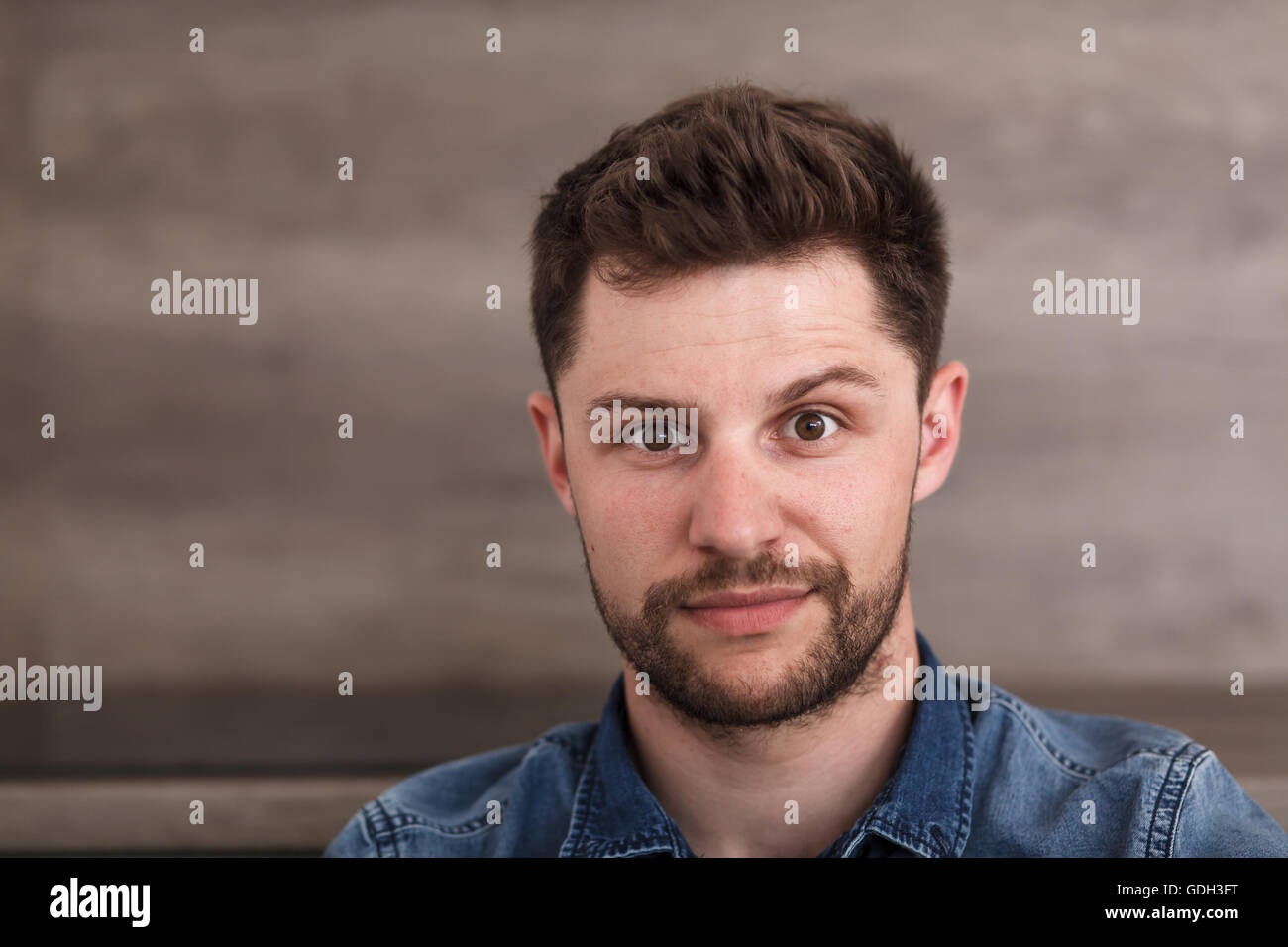 Portrait of a young successful man. A bearded man in a blue shirt. Stock Photo