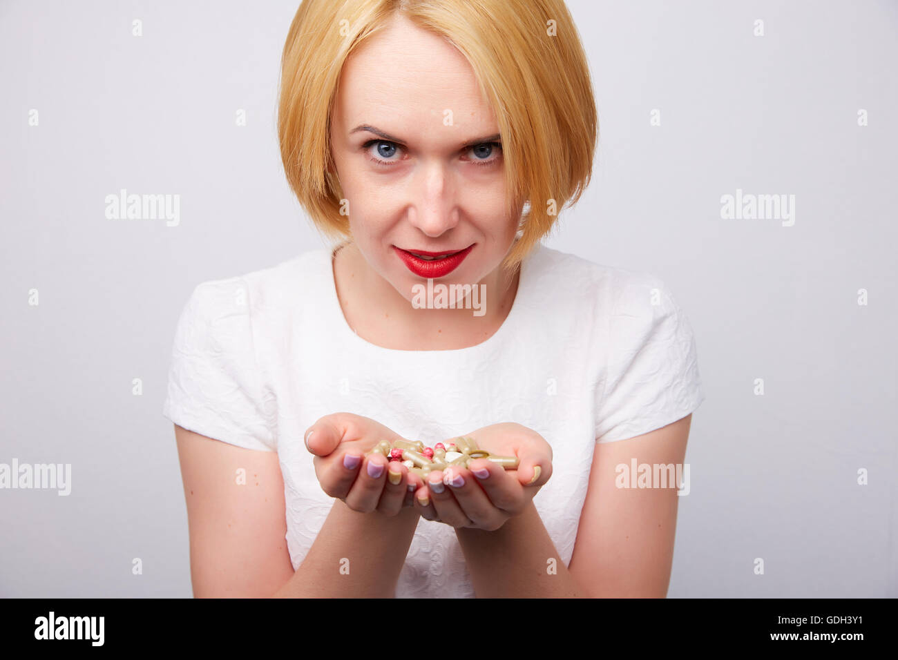 many pills and capsules in women in the hands Stock Photo