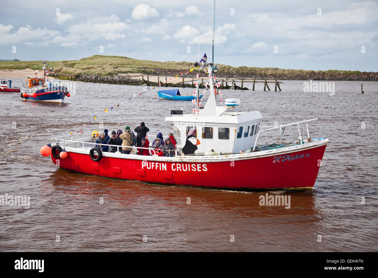 A group of birders from Scotland leaving Amble harbour on a short cruise around Coquet Island. Stock Photo