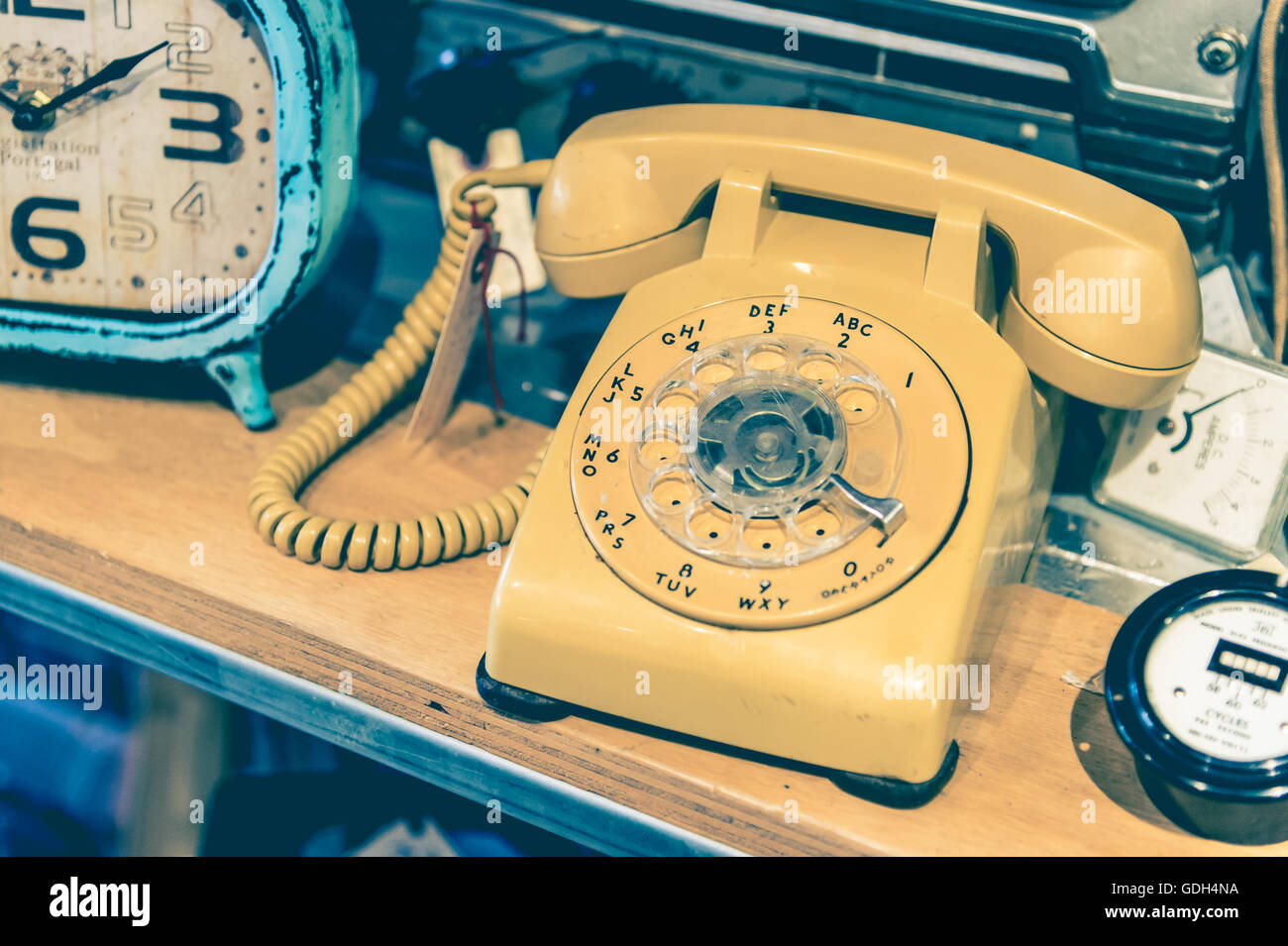 Yellow vintage Rotary Phone with toned effect Stock Photo