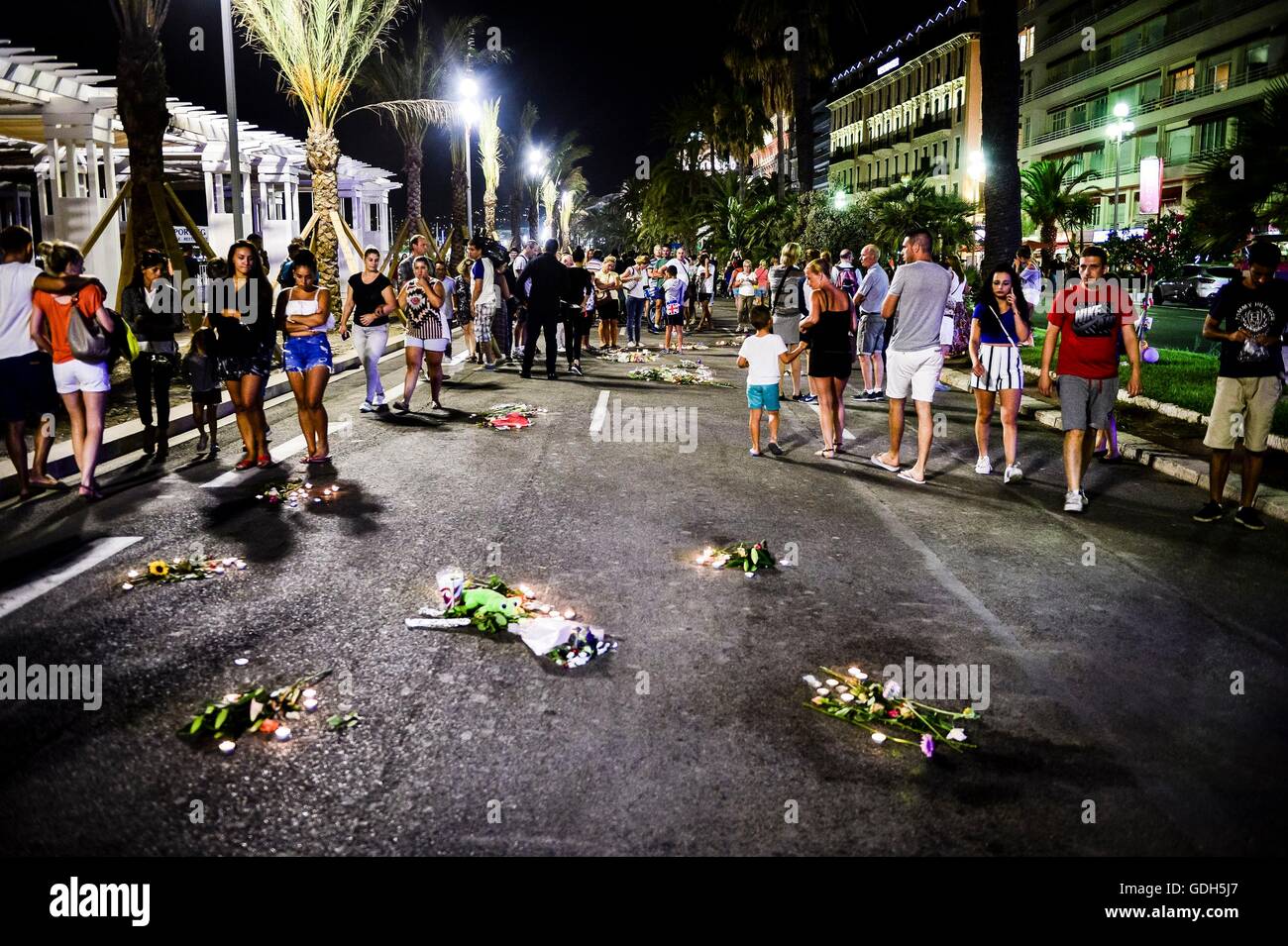 Tributes are placed over the blood stained road where bodies fell on the Promenade des Anglais, Nice, as French detectives are trying to piece together the circumstances that left at least 84 people dead and scores injured after a terrorist deliberately drove a lorry into Bastille Day revellers, before being fatally wounded in a stand-off with armed police. Stock Photo