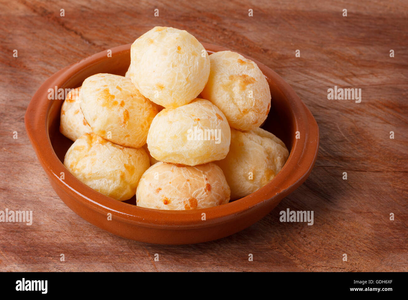 Brazilian snack cheese bread (pao de queijo) in bowl on wooden table. Selective focus Stock Photo