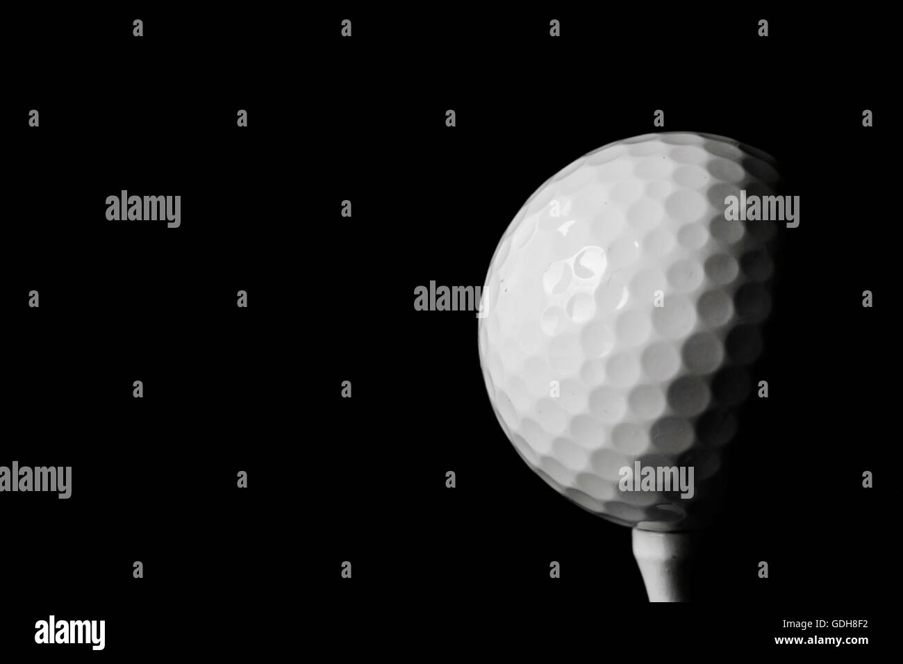Golf ball black background Stock Photo - Alamy