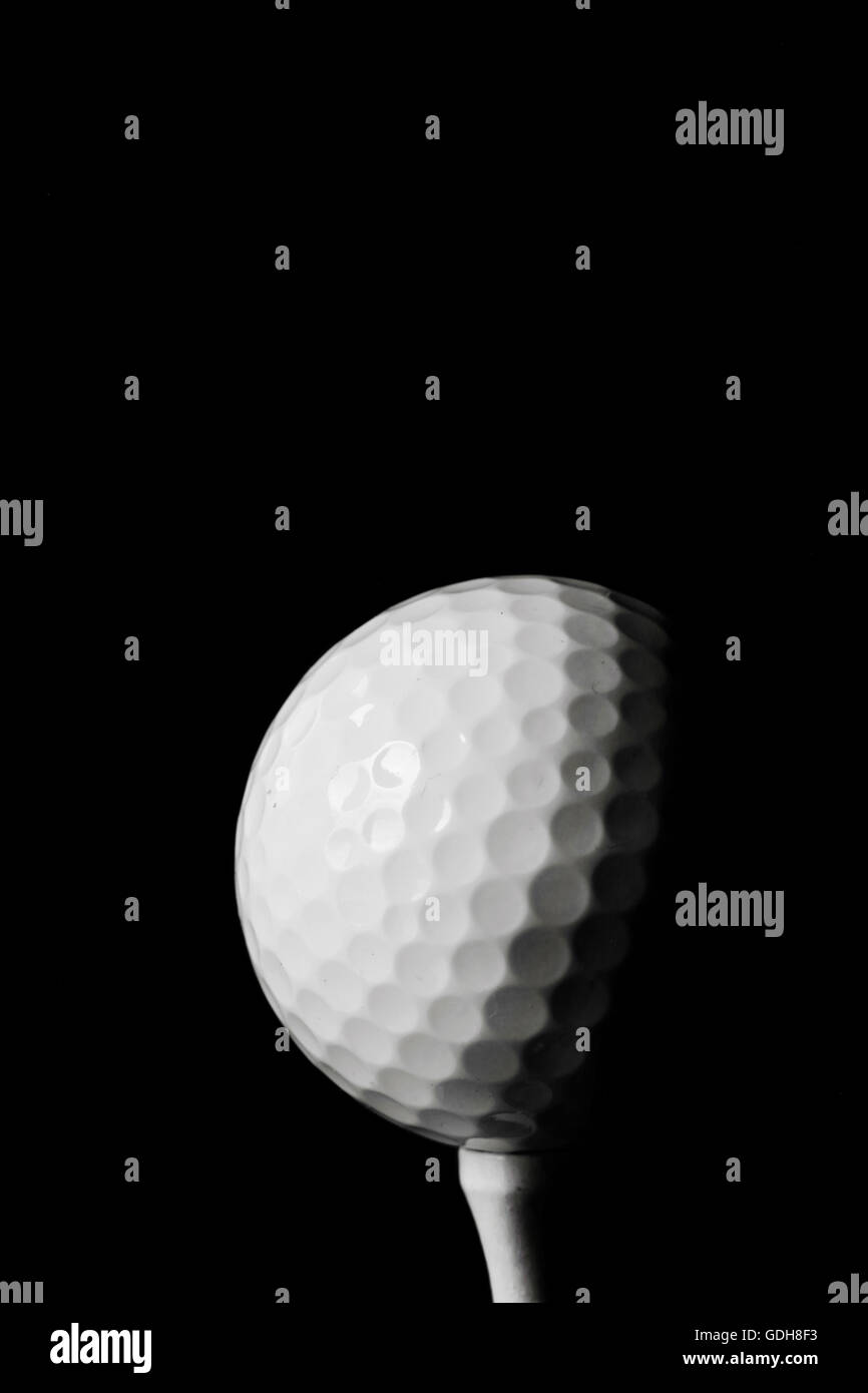 Golf ball black background Stock Photo - Alamy