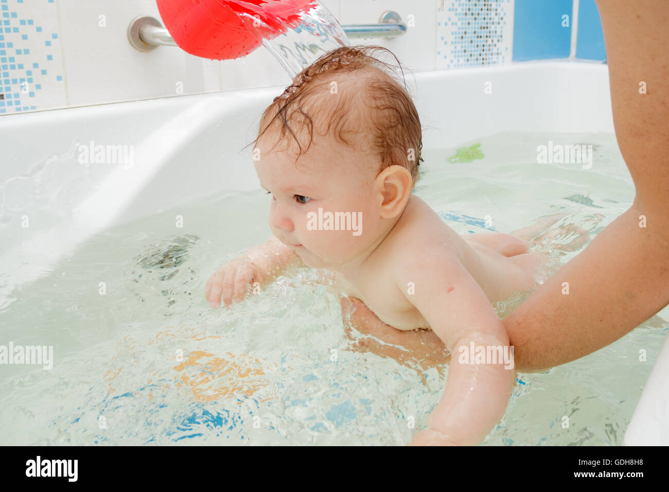 Little newborn baby girl bathe and swim Stock Photo Alamy