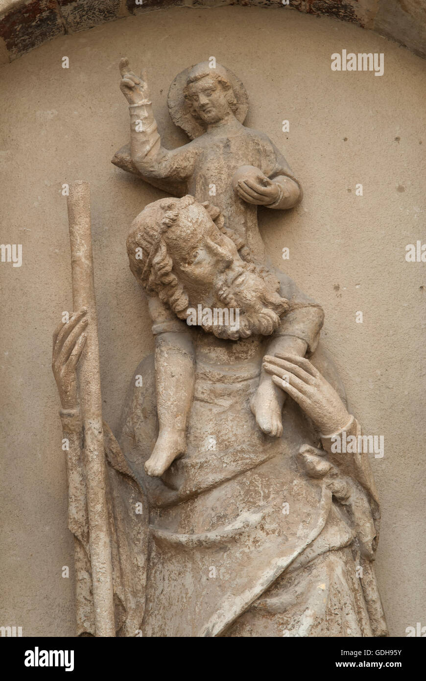 St Christopher 14th-century statue statue plaque fixed to a village wall Boulbon south of France 2016.  HOMER SYKES Stock Photo