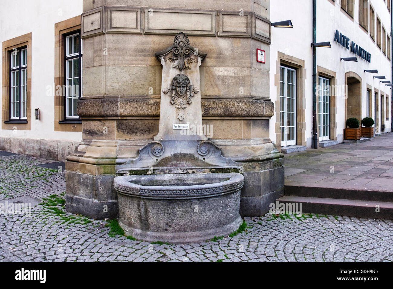 Water fountain at corner of the Alte Kanzlei, The Old Chancellery. Historic building now a German restaurant, Stuttgart Stock Photo