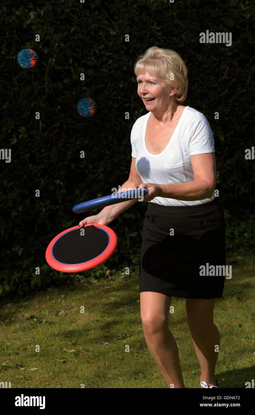 Elderly woman exercising with a ball and plastic discs Stock Photo