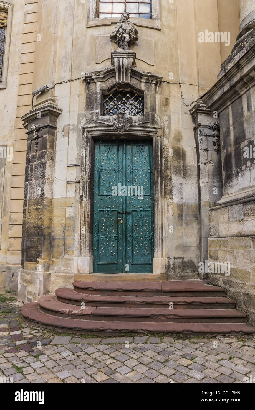 Steps and a green door of a church in Lviv, Ukraine Stock Photo