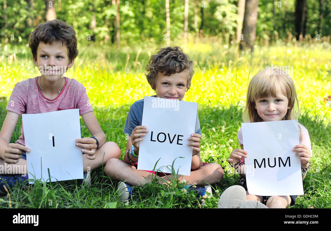 Kids with a sign I love mum Stock Photo