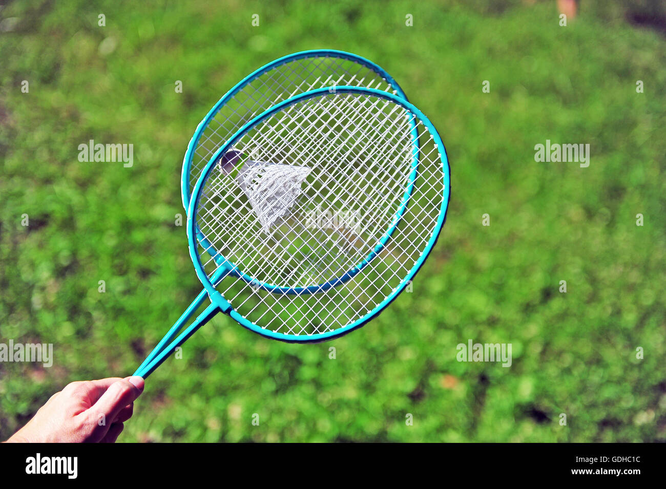 Hand holding the badminton rackets Stock Photo