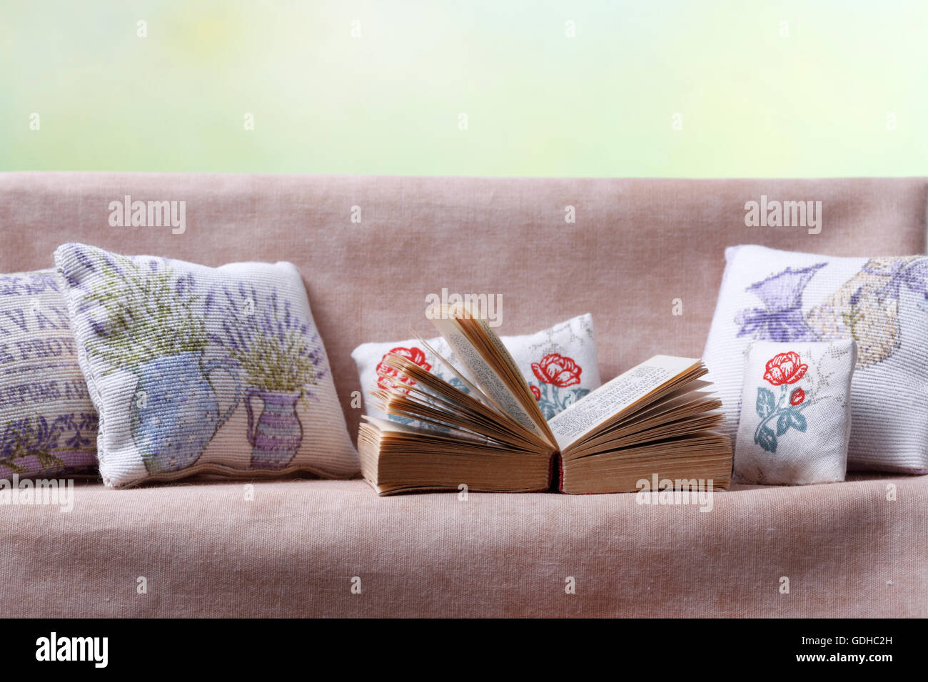 Sofa with cushions and book Stock Photo Alamy