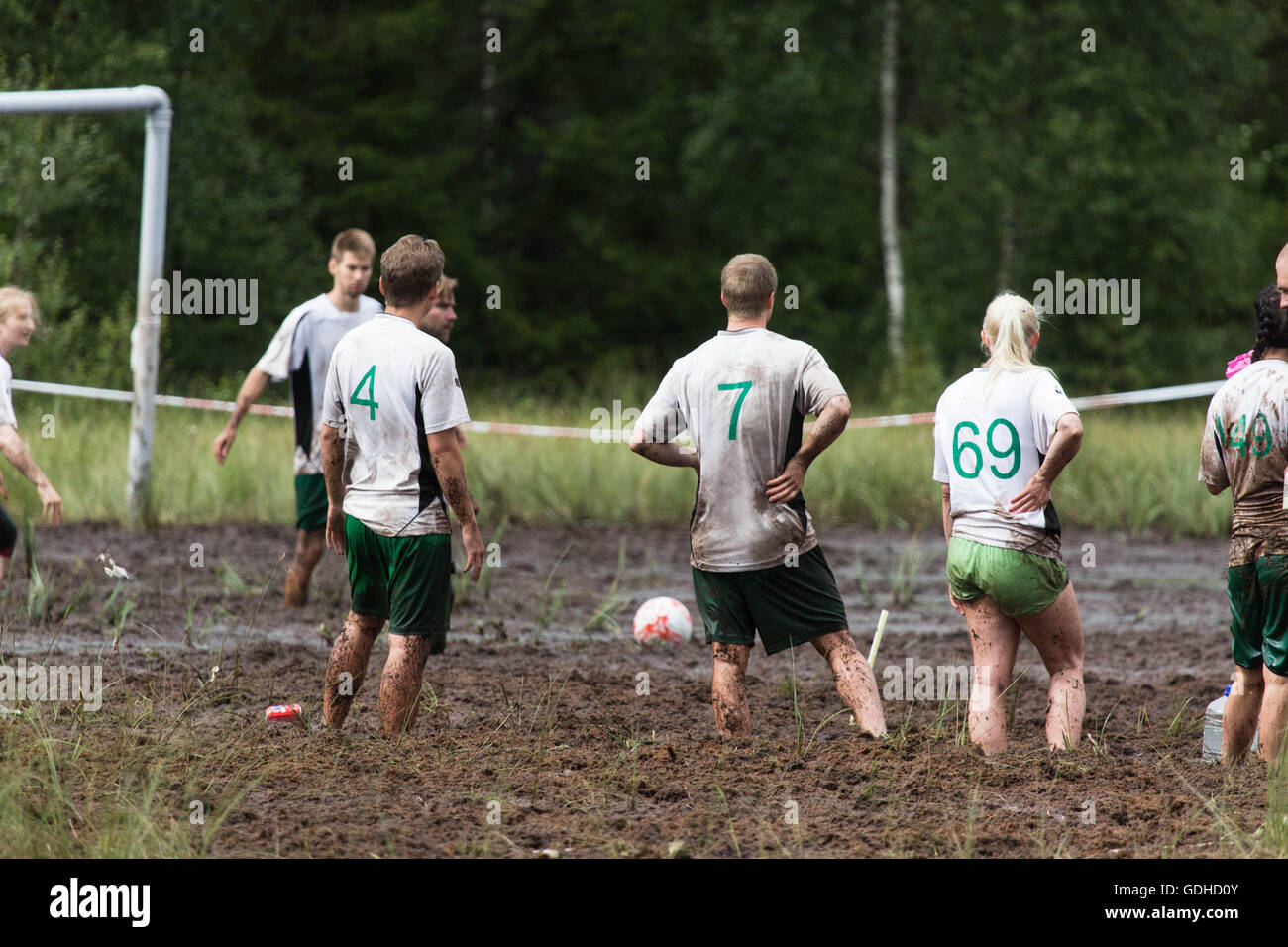 Hyrynsalmi, Finland, July 16 2016. The Swamp Soccer World Championship 2016 at Ukkohalla in Hyrnsalmi. About 2000 competitors take part every year in the world's oldest swamp soccer tournament. Pictured: Action and crowd scenes from the knockout stages on the rainy second day. Credit:  Rob Watkins/Alamy Live News Stock Photo