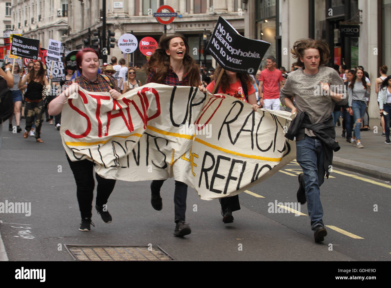 London, UK. 16th July, 2016: Protesters run to catch up on the march at Regent Street. Hundreds of people take part in a demonstration outside the BBC offices at Portland Place and march to Parliament Square WC1, united in demanding for an end to Austerity, No To Racism and demanding and end to the Tory rule. The demonstration on 16 July called by the People's Assembly and Stand Up to Racism is the positive and united response After the Brexit referendum. Credit:  david mbiyu/Alamy Live News Stock Photo