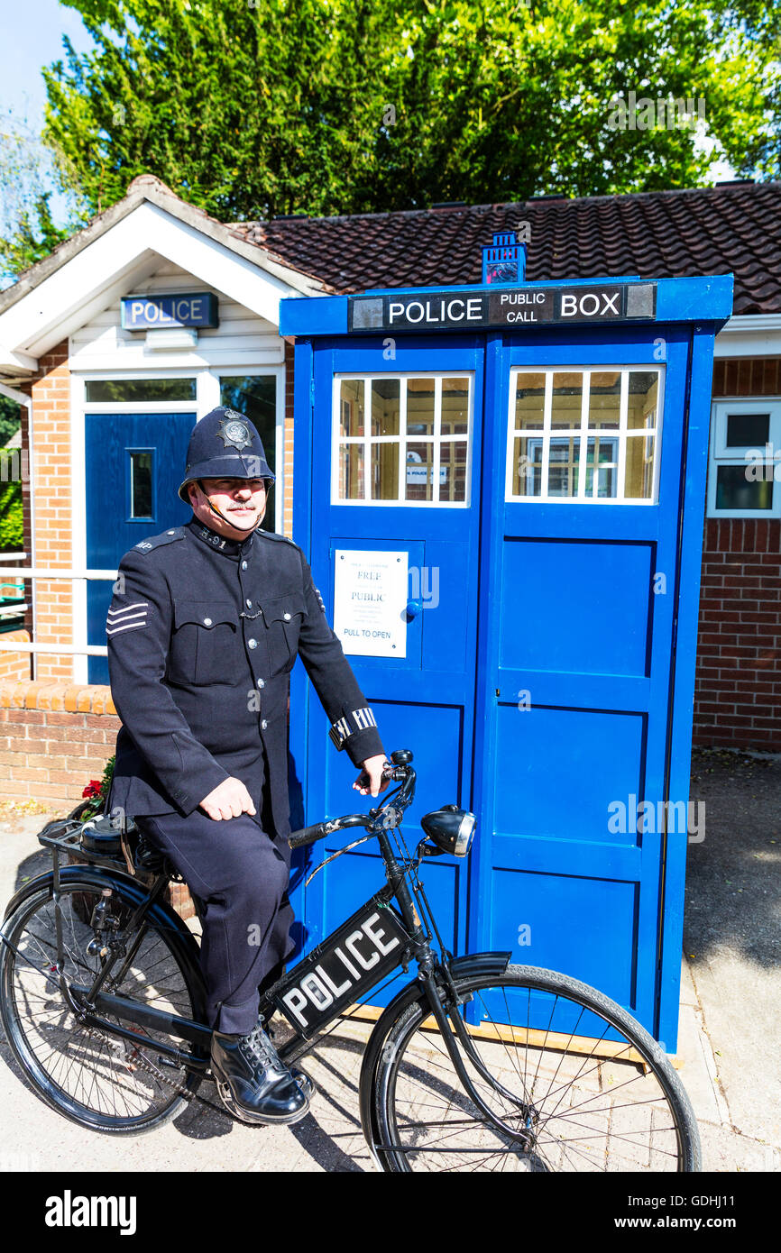 Policeman police box bike biker copper outside 1940's police phone box tardis on patrol traditional uniform helmet stripes on sleeve from era Woodhall Spa 1940's weekend people ww2 style look attire Credit:  Tommy  (Louth)/Alamy Live News Stock Photo