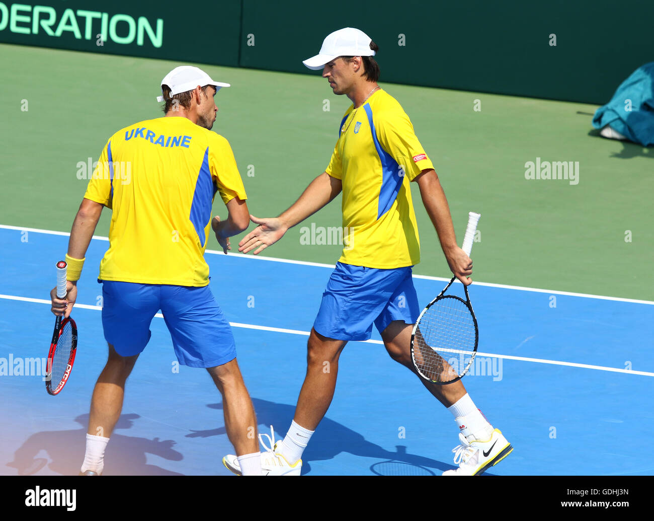 Kyiv, Ukraine. 16th July, 2016. Denys MOLCHANOV (R) and Artem SMIRNOV of  Ukraine react during BNP Paribas Davis Cup pair game against Austria at  Campa Bucha Tennis Club in Kyiv, Ukraine. Credit: