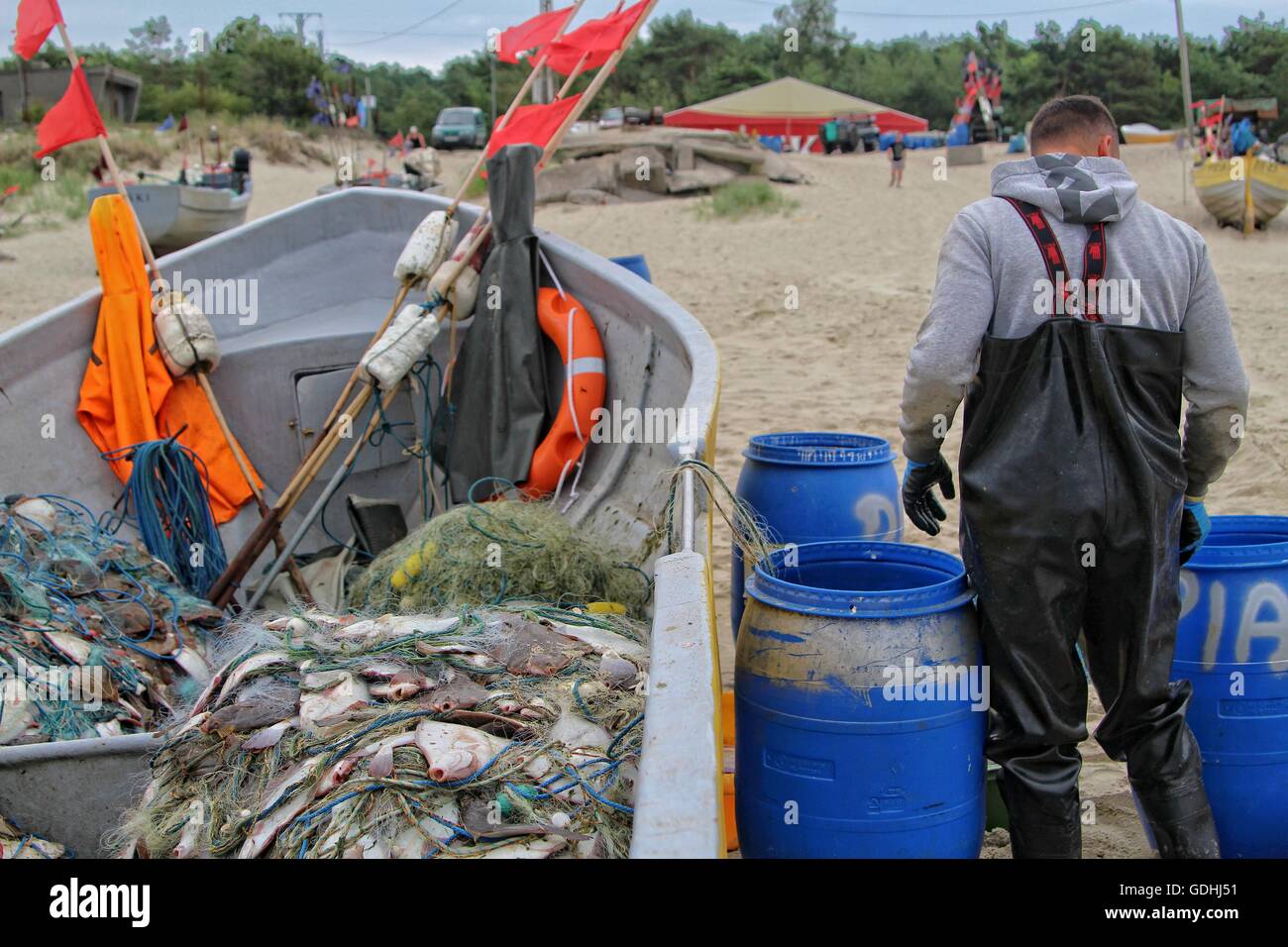 Piaski, Poland 17th, July 2016 Fishermen in Piaski return from the Baltic sea with caught flounders. Flounders (Platichthys flesus) and herring are the main basic species of fish caught this time of year in Baltic by Polish fishermen. Stock Photo
