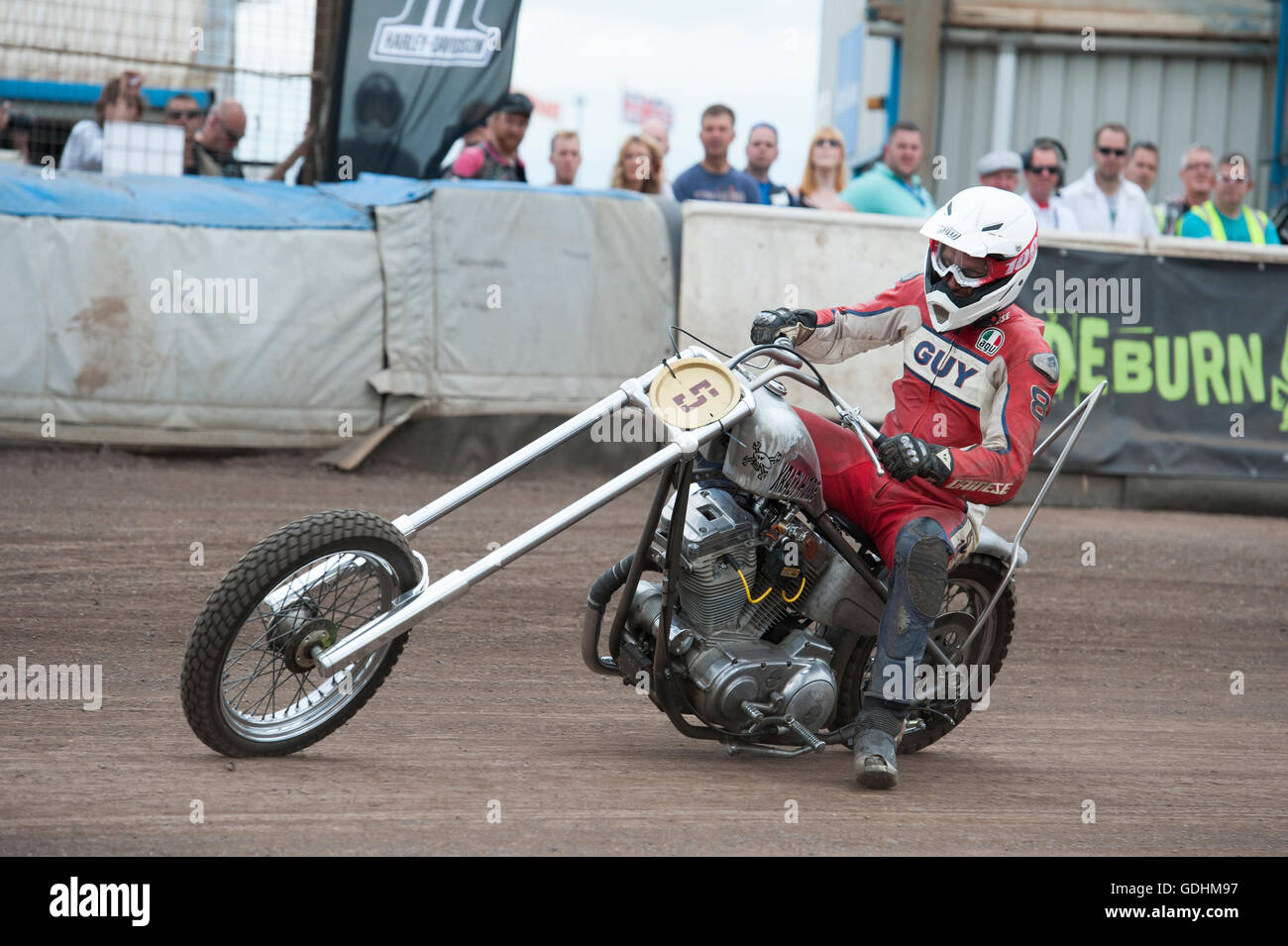 Kings Lynn, Norfolk, United Kingdom. 16.07.2016. Fifth annual Dirt Quake festival at the Adrian Flux Arena, Norfolk. Dirt Quake is racing road bikes on a dirt track. Lorry mechanic, Mortorbike Racer and TV celebrity Guy Martin races on a Crazy Horse Harley Davidson (pictured) and World Superbike racer, Carl Fogerty MBE races a Triumph. Classes include Inappropriate Road Bike, Ladies, and Street Tracker. Stock Photo