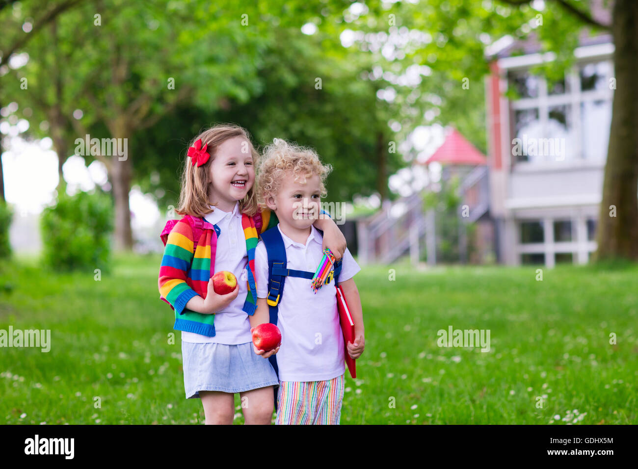 Child going to school. Boy and girl holding books and pencils on first ...