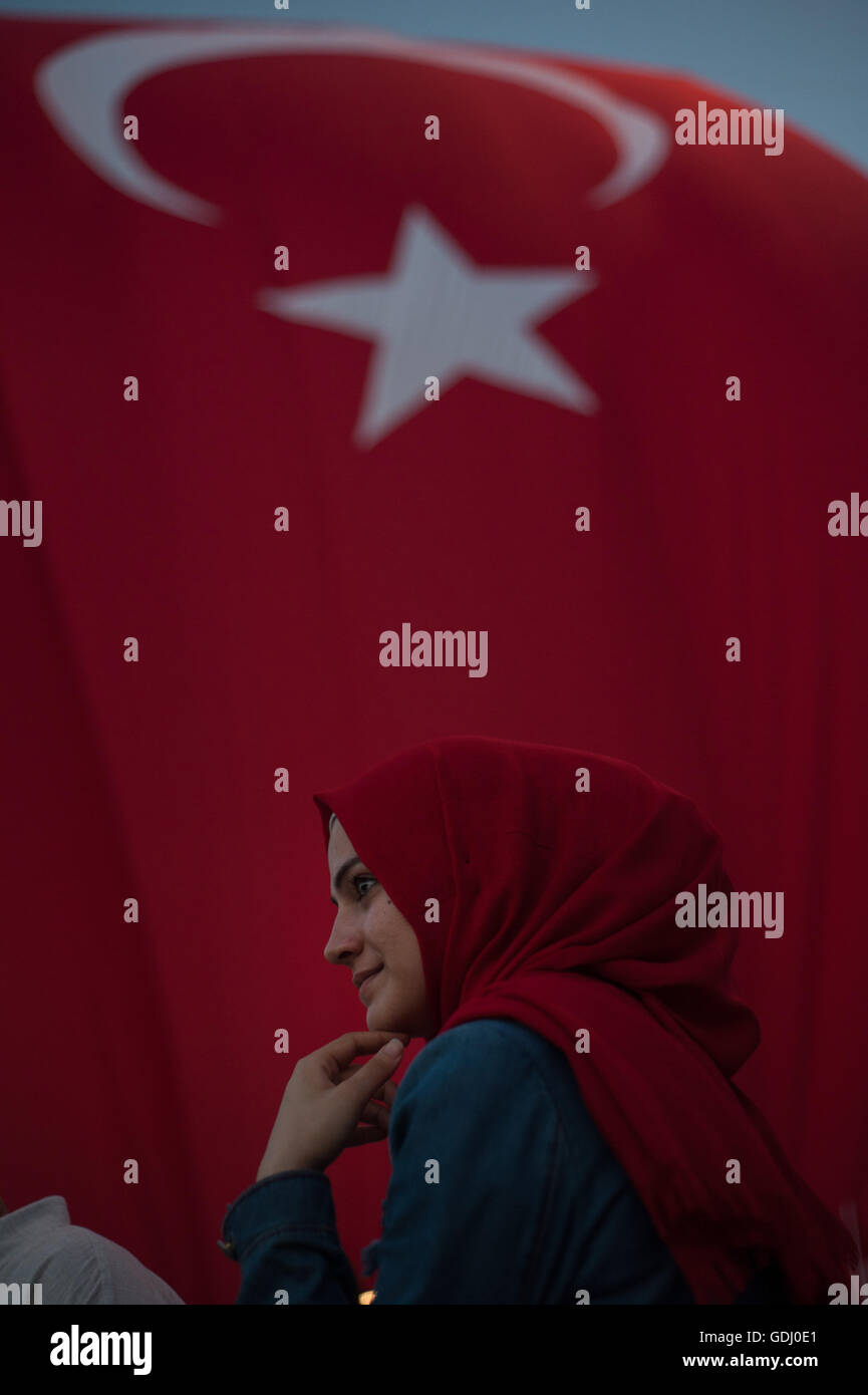 Muslim woman wearing red headscarf with Turkish flag  Istanbul Turkey Stock Photo
