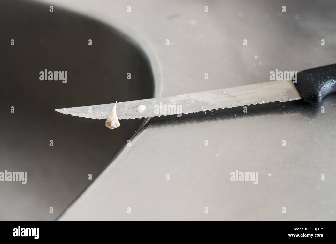 Dirty knife after cutting cheese Stock Photo