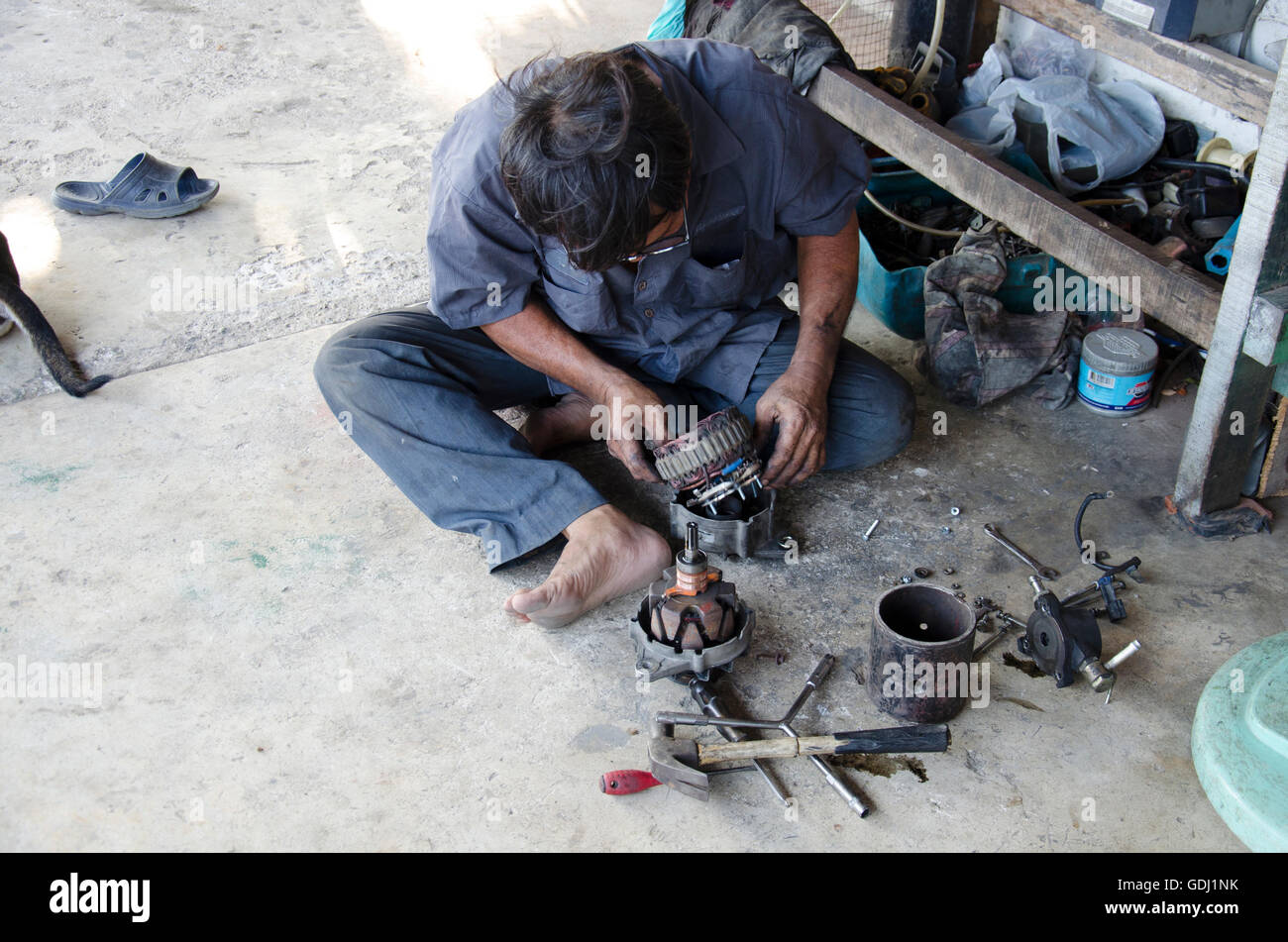 Old man 60 year thai people professional automotive motor mechanic