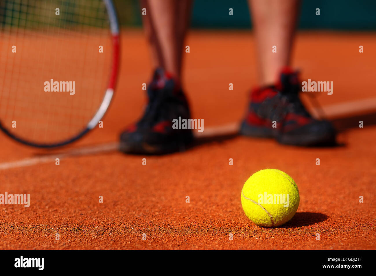 tennis court with tennis ball and man legs on background Stock Photo Alamy