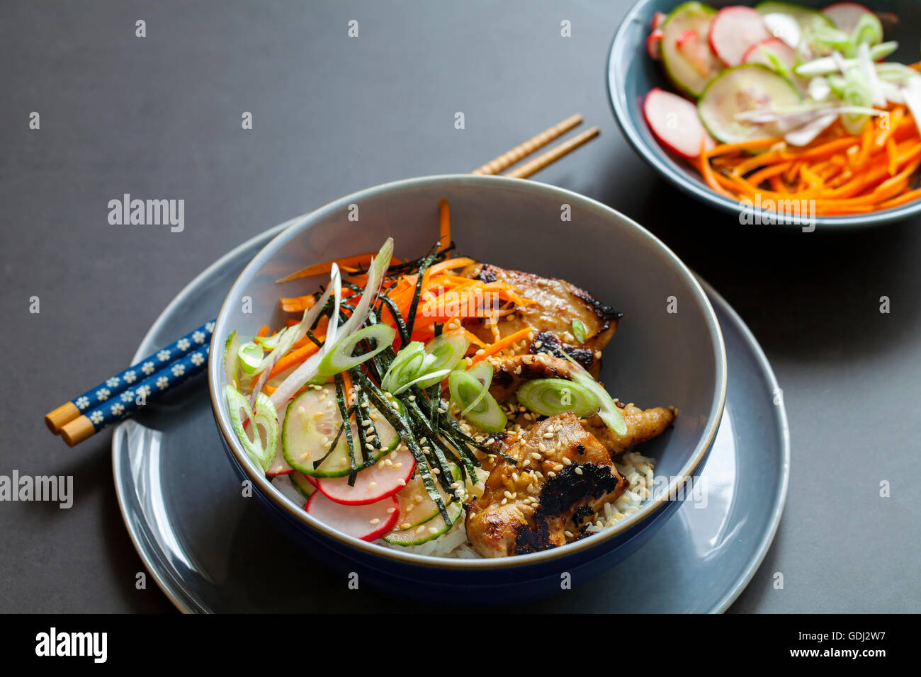 Oriental bowl of rice, caramelized chicken thighs and pickled vegetables Stock Photo Alamy