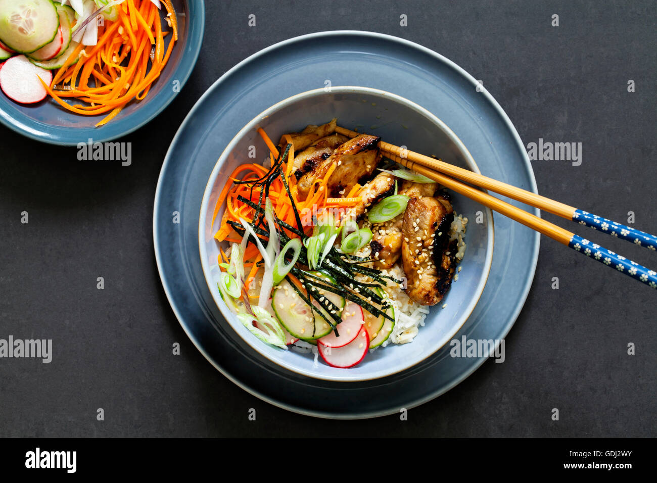 Oriental bowl of rice, caramelized chicken thighs and pickled vegetables Stock Photo Alamy