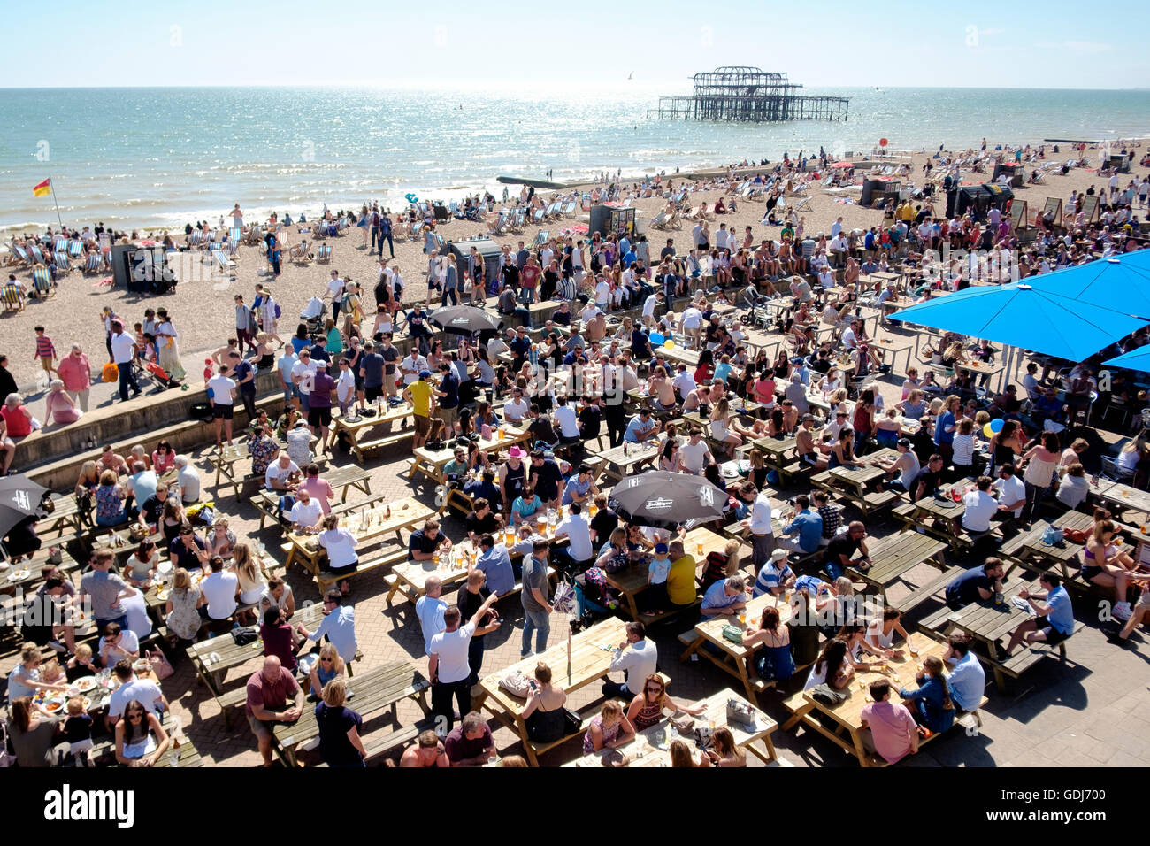 July 2016: people drinking at the Brighton Music Hall pub on the lower esplanade in Brighton adjacent the beach. Stock Photo