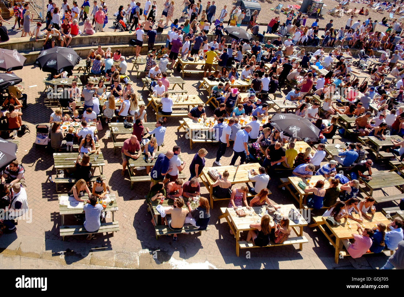 July 2016: people drinking at the Brighton Music Hall pub on the lower esplanade in Brighton adjacent the beach. Stock Photo