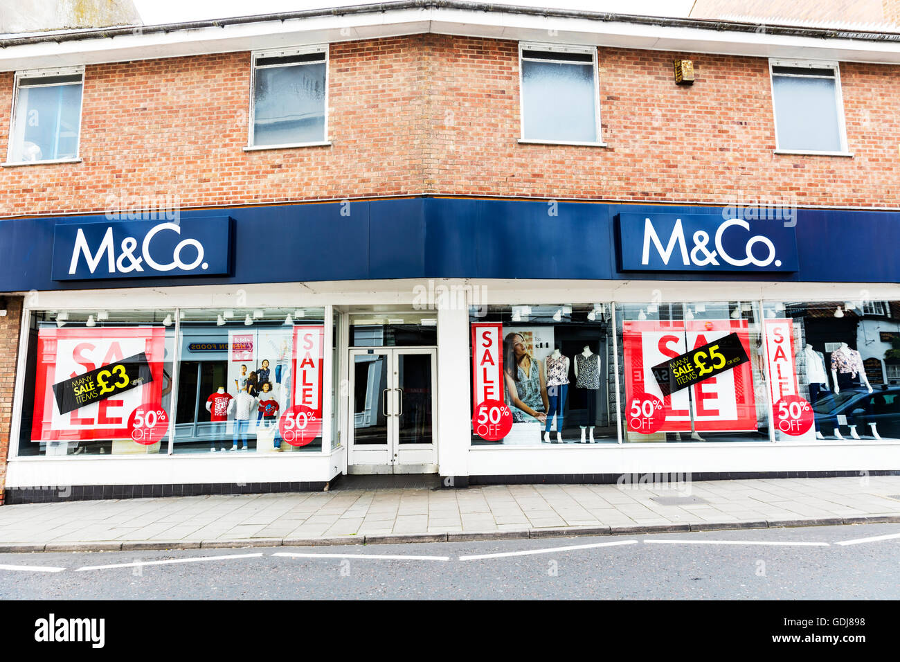 M&Co shop store sign signs clothes shops stores high streeet building exterior sale sales UK England Stock Photo