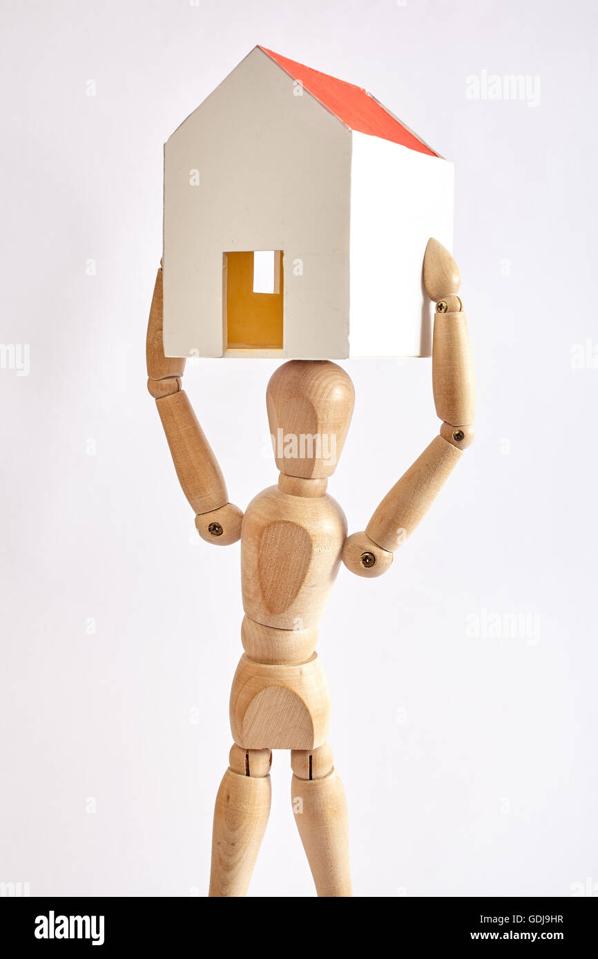 Dummy carrying small house on white background Stock Photo Alamy