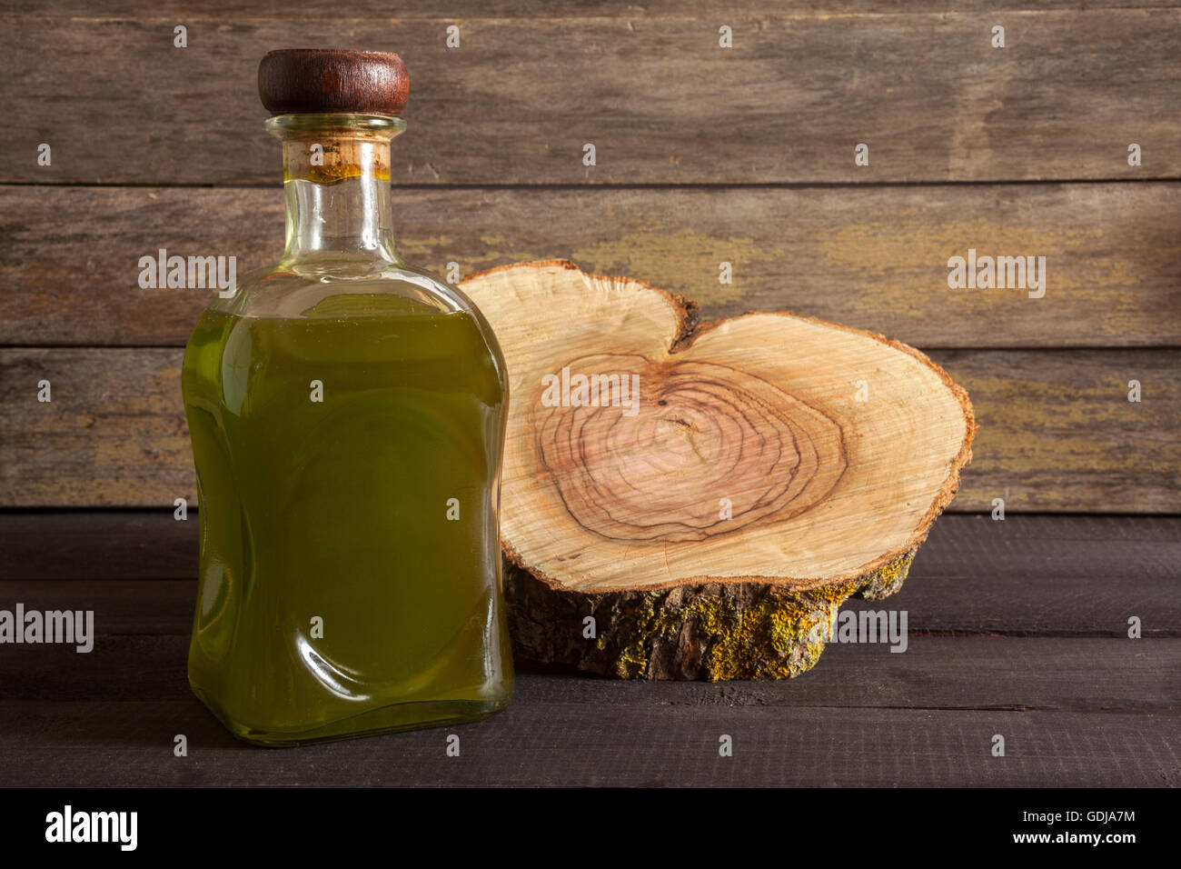 Olive oil bottle on wooden background Stock Photo
