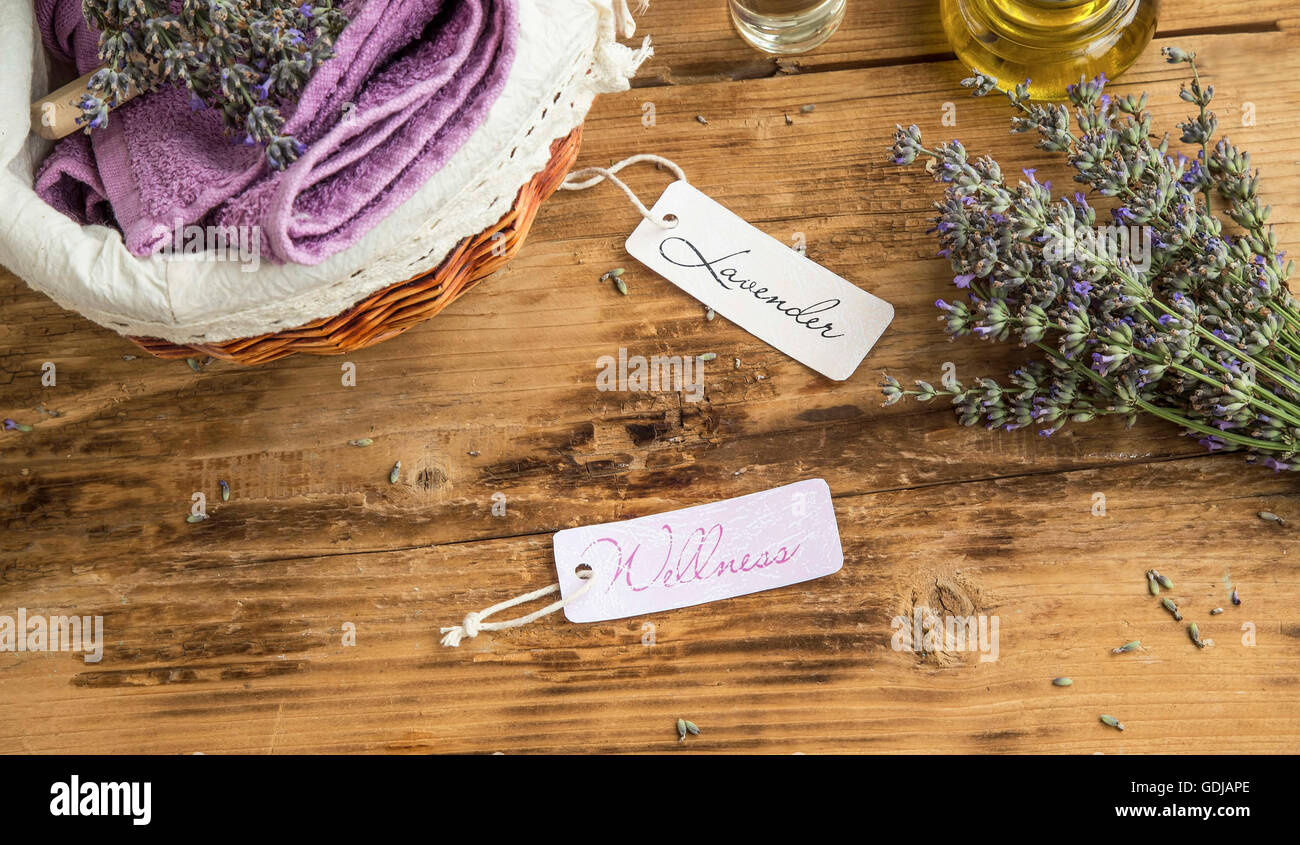 Lavender welness spa still life with labels, candle, body oil, lavender flowers and towels Stock Photo