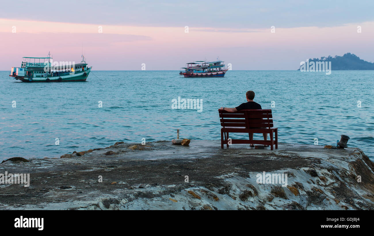 Man sitting on dock hi-res stock photography and images - Alamy