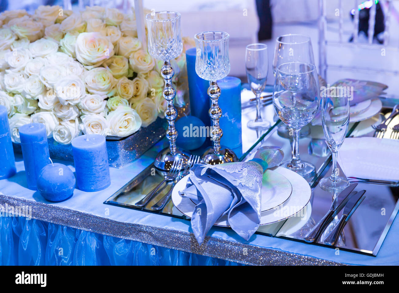 Wedding dinner table reception. Wedding table decoration - white branch  from a tree, crystal pendants, candles in glass spheres, on a white table  with Stock Photo - Alamy