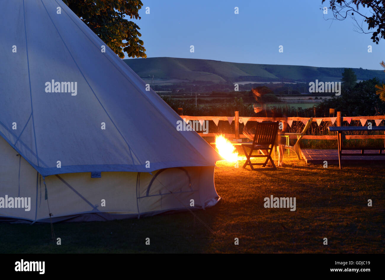Bell tent and campfire - glamping in the uk Stock Photo
