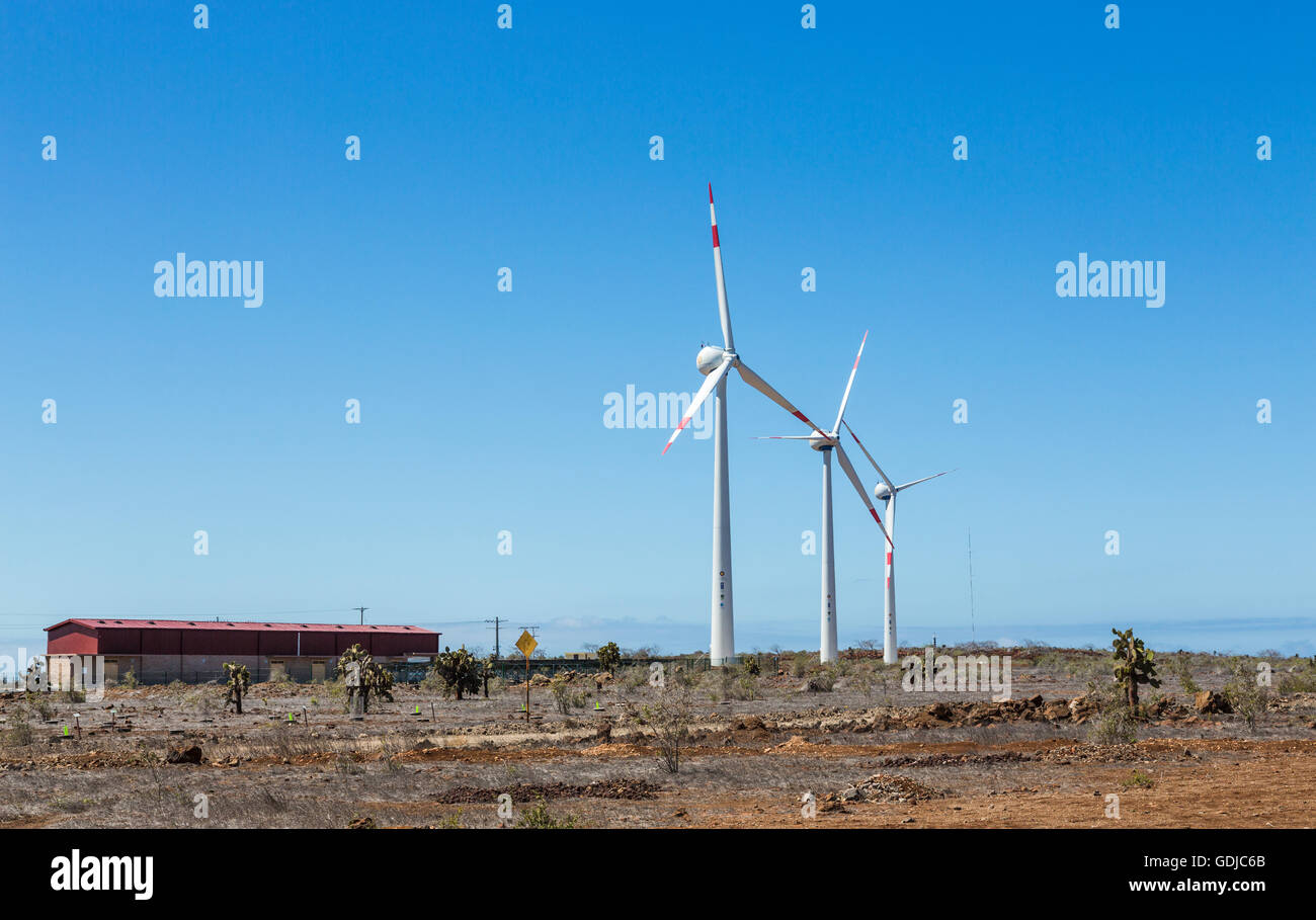 Wind turbines at Seymour Airport, island of Baltra, Galapagos Islands, Ecuador, South America on a sunny day with a blue sky Stock Photo
