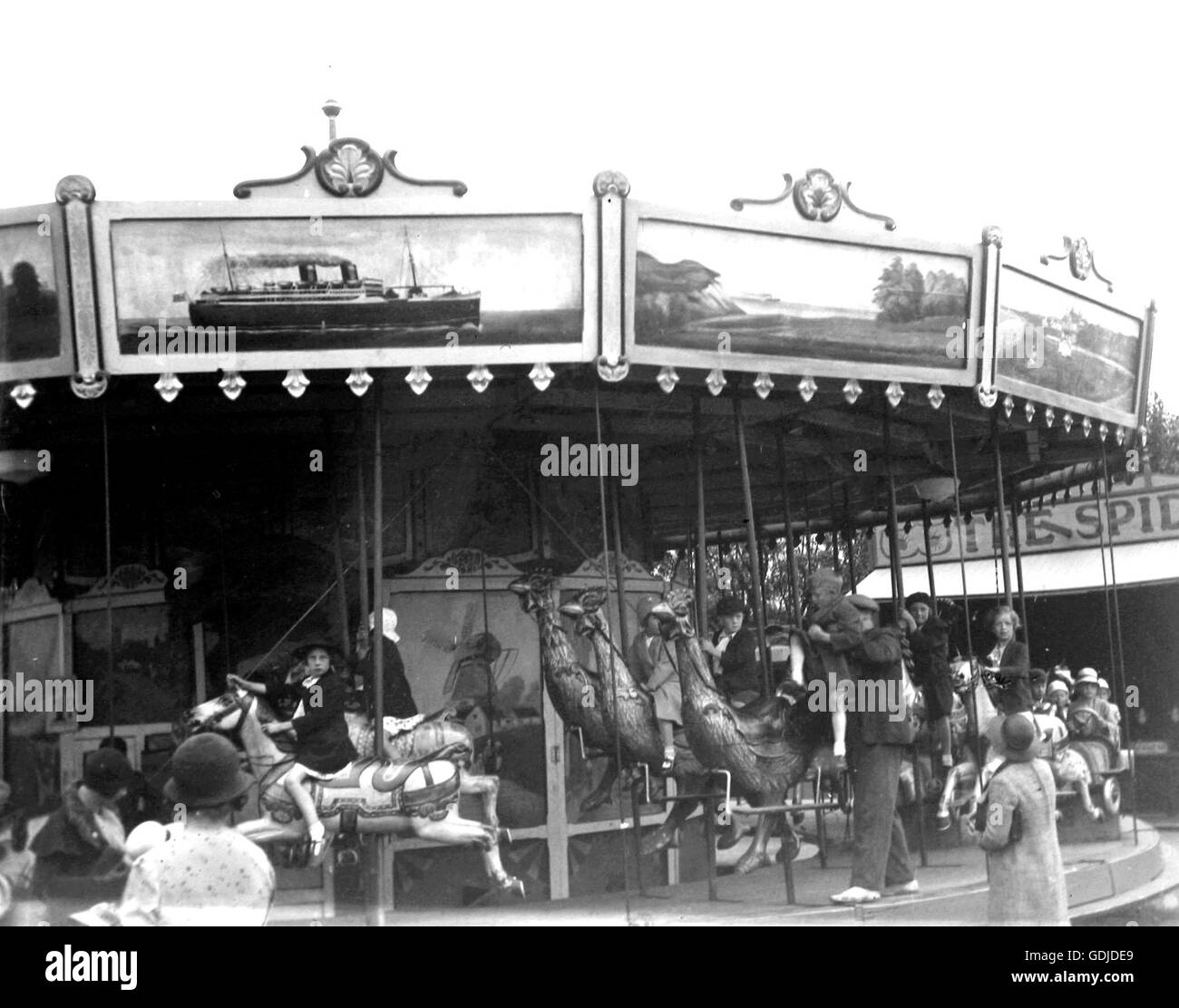 Children on a funfair carousel circa 1920. Photo by Tony Henshaw Stock Photo