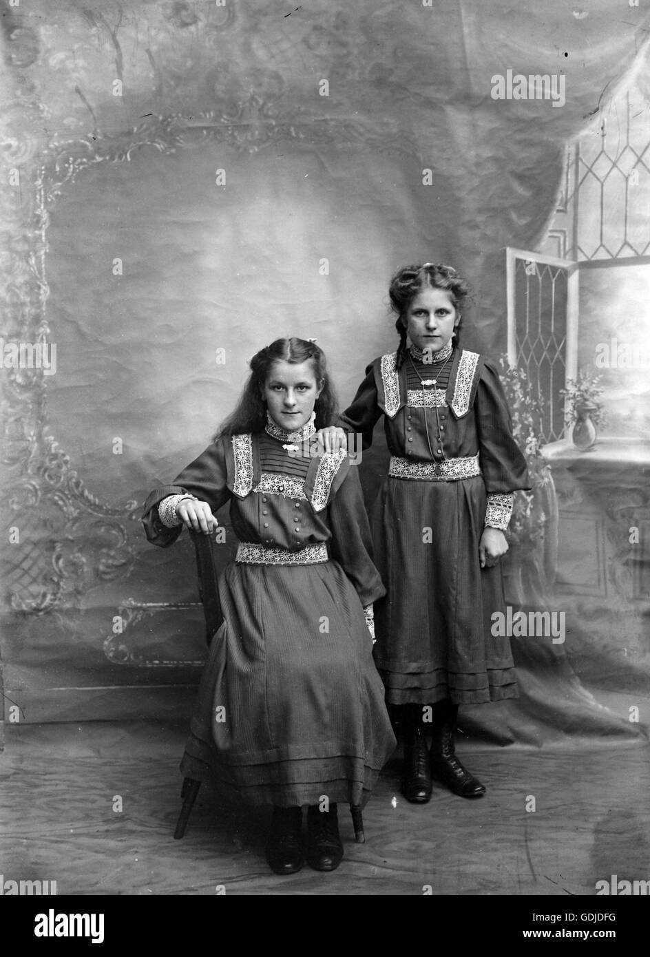 Sisters pose in the studio setting. C1910. Photograph by Tony Henshaw Stock Photo