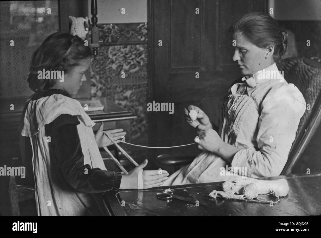 'Home Industry' a girl learning knitting skills. Social history observations labelled Mr W. Frith of Rotherham Photographic Society c1910. Photograph by Tony Henshaw Stock Photo