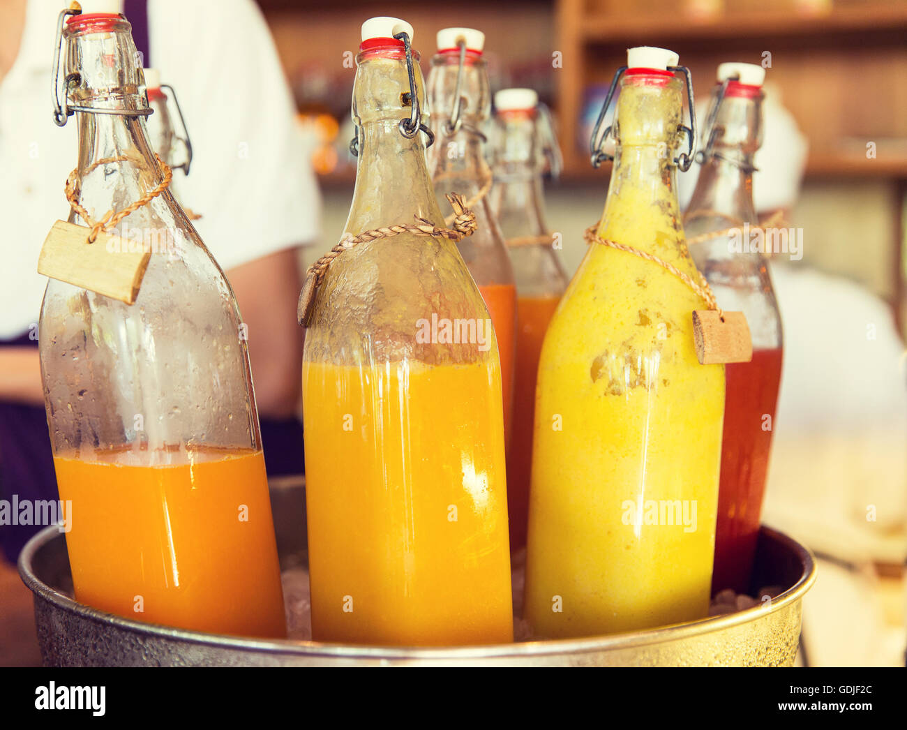 bottles of juice in ice bucket at market Stock Photo Alamy