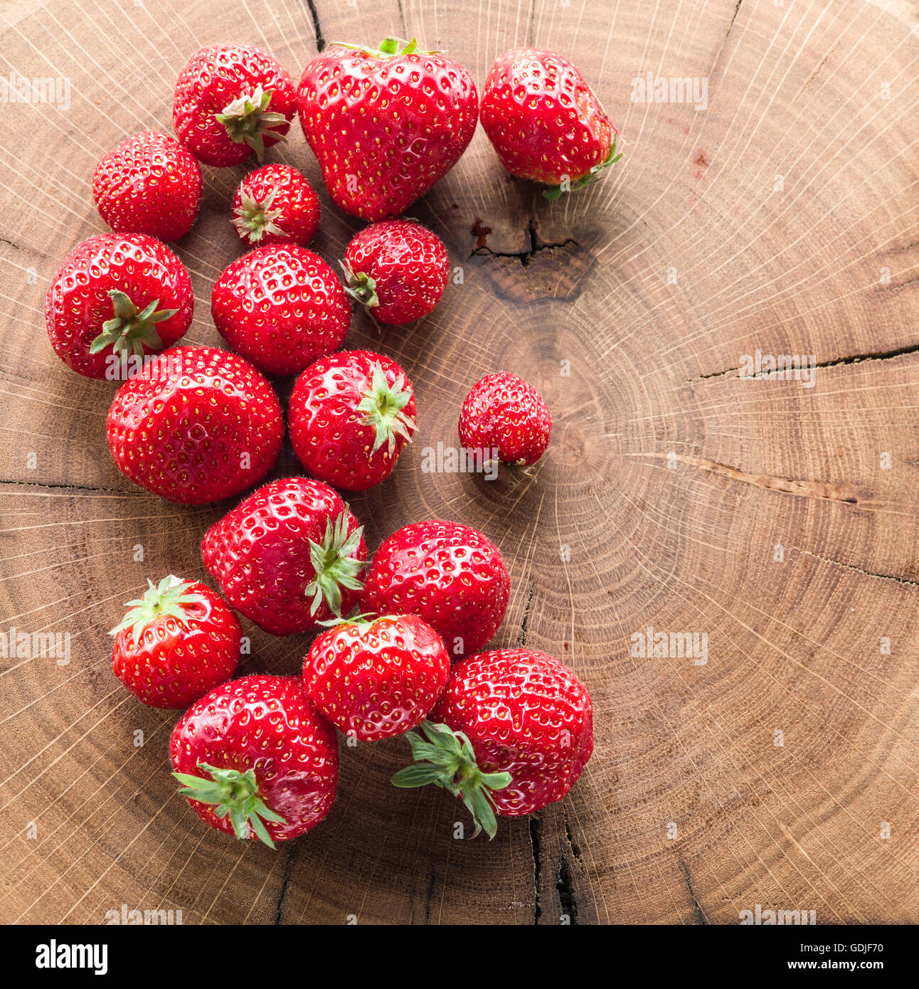 Strawberries on the old wooden board. Stock Photo