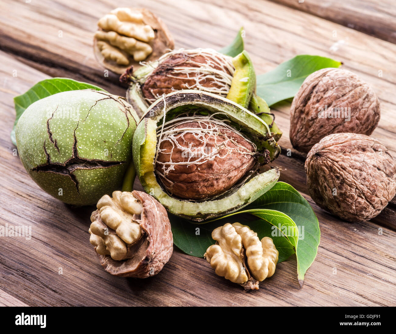 Walnut and walnut kernel on the wooden table. Stock Photo
