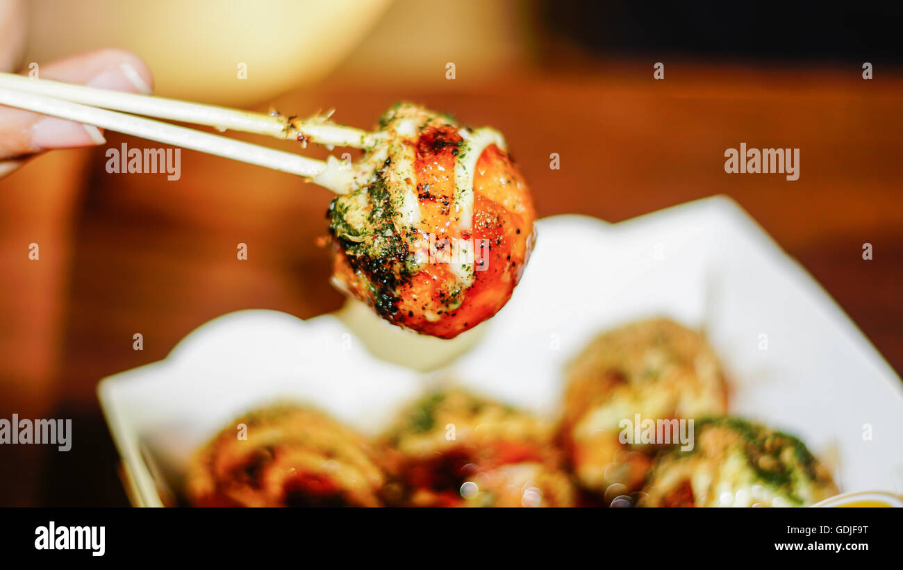 Takoyaki, delicious Japanese style octopus pancake, topping with multiple seasoning, very famous